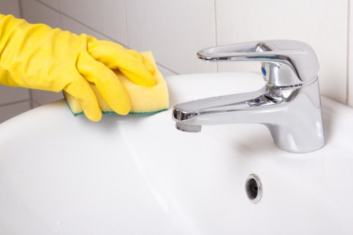 Cleaner working on a corner sofa in a local Dulwich property