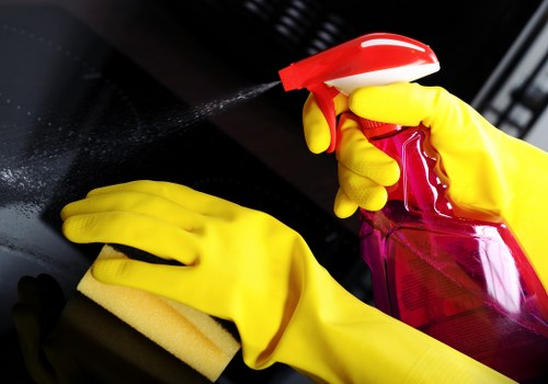 Professional cleaner sanitising a bathroom during domestic cleaning in Dulwich